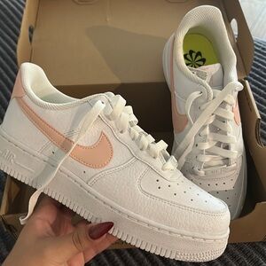 BRAND NEW Nike women’s Air Force 1’s. White with a pink logo.